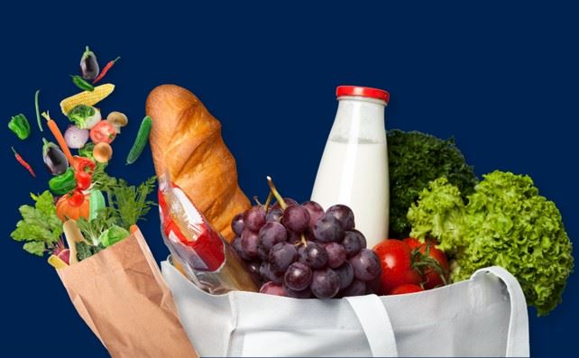 Bag of groceries containing fruit, vegetables, bread and milk